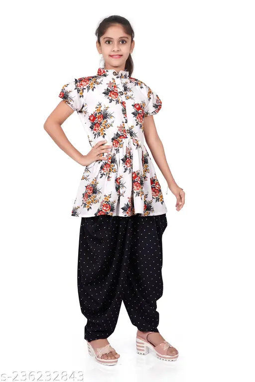 White and black crepe girl kurta set with printed patterns, short sleeves, for ages 4-15 years old. Indian traditional attire on display stand