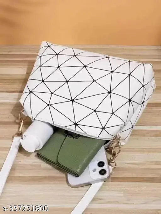 Women's white and black geometric design PU sling bag for college and office use. Adjustable sling belt, spacious compartment, multi-utility pockets, with top zipper closure and comfortable shoulder strap. Made in India