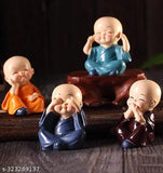 Multicolor polyresin baby monk Buddha set of 4 decorative showpieces, handcrafted from India