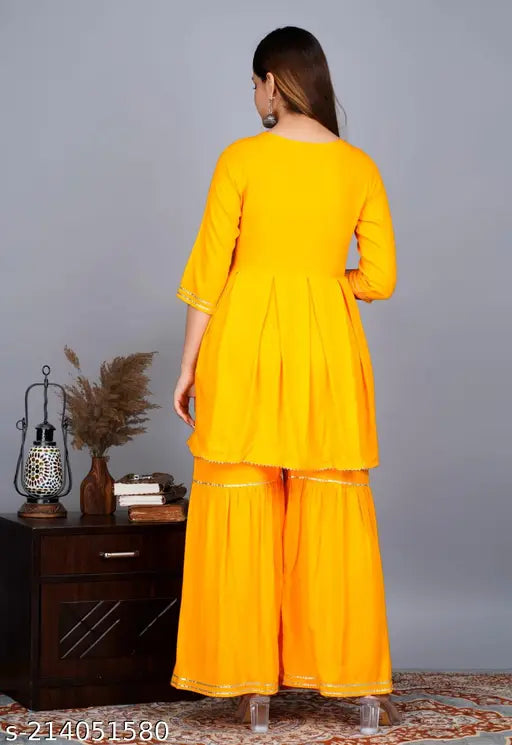 Yellow Rayon Kurta Set with Sharara and Dupatta, stitched net design on three-quarter sleeves, modern Indian fashion for spring-summer seasons