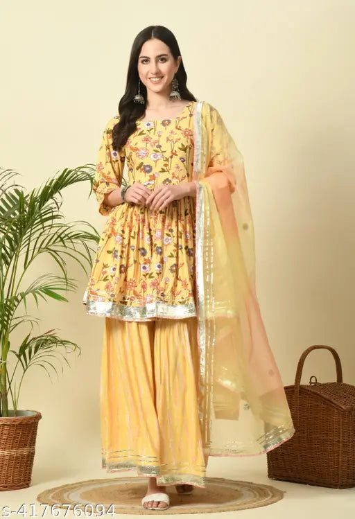 Mustard floral rayon kurti and sharara set with dupatta - vibrant printed rayon kurti and bottomwear for women, stitched net design on display