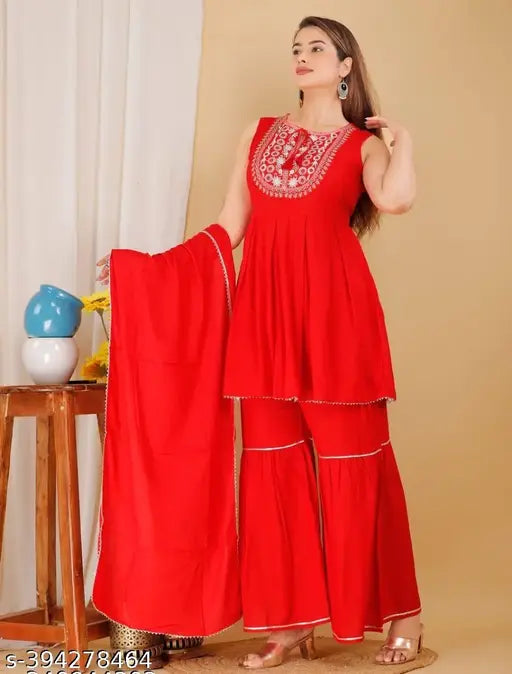 Red rayon kurti set with sharara and dupatta: Women's A-line sleveless kurta, sharara, and dupatta set in vibrant red color. High-quality rayon fabric ensures comfort and elegance for various occasions