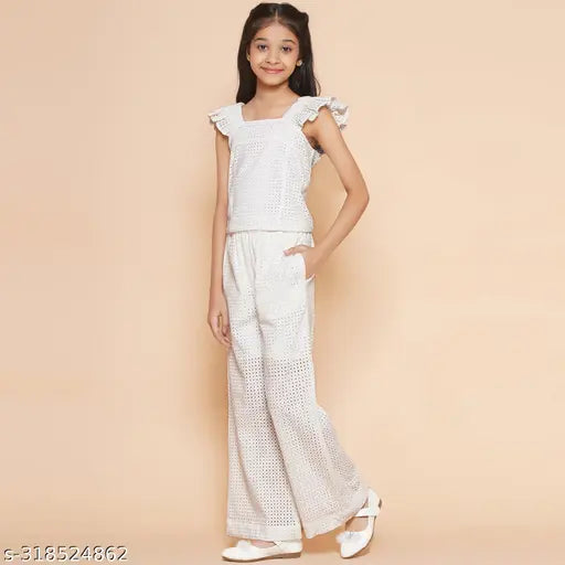 White cotton schiffli embroidered cuff sleeve top and elasticated pant set for girls, self-designed Indian attire on display