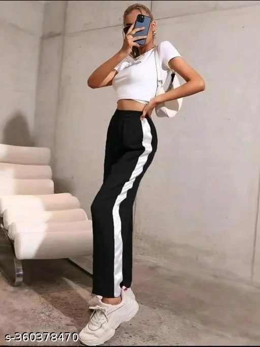 Black and white women's/girls lycra trousers, narrow fit and solid pattern, ideal for fashion-forward outfits