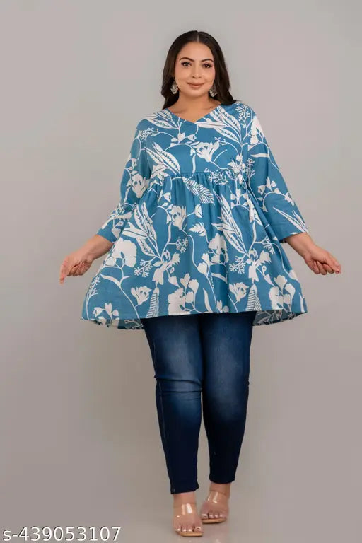 Teal rayon plus size short kurti, featuring three-quarter sleeves and trendy print. Beautiful color, flared pattern, perfect for comfortable fashion-forward looks. Made in India