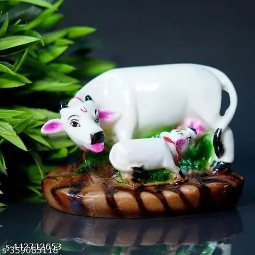 White Poly Resin Kamdhenu Cow & Calf Statue for temple, home decor, or car dashboard. Dimensions: 15cm (L) x 9cm (H) x 7.5cm (B), handcrafted in India