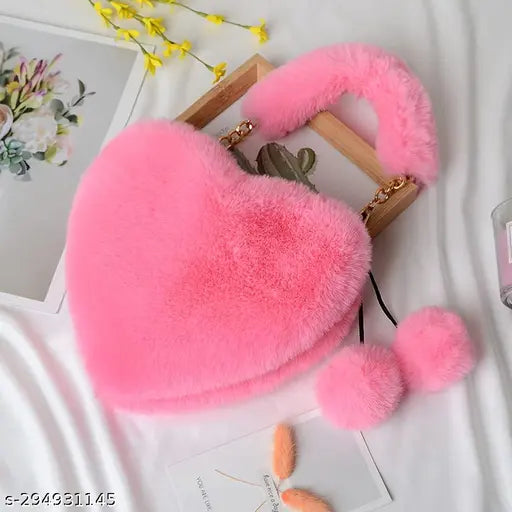 Synthetic faux fur heart-shaped sling bag with pompoms, suitable for various occasions. Soft and lightweight, ideal for everyday essentials. Imported from India