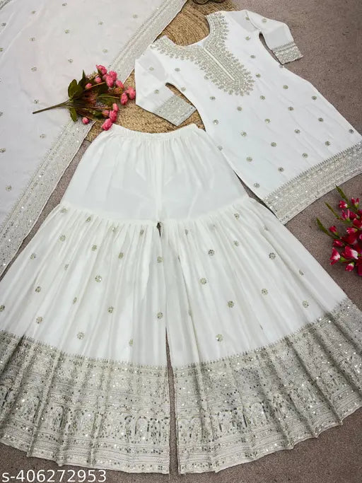 White Chinnon Silk Kurti Replica: Embroidered three-quarter sleeve top with dupatta and bottomwear, full stitched ready to wear. Pure Chinnon silk with heavy embroidery sequence work, lace border on dupatta. India origin