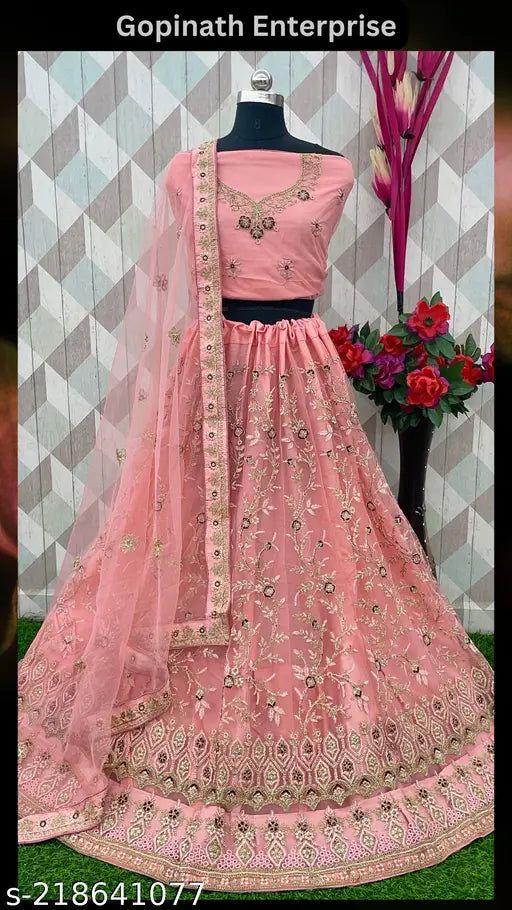 Pink net Lehenga Choli Set with Dupatta and Blouse, embellished with intricate embroidery. Handcrafted by Gopinath Enterprise, India. Traditional Indian bridal wear for women's weddings or parties