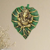 Green brass Ganesh idol decorative wall statue, intricately detailed with leaf design, traditional Indian craftsmanship