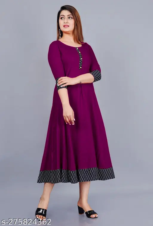 Purple rayon round pleated flared kurti with three-quarter sleeves, suitable for casual and formal occasions. Hand wash or machine wash. Made in India. Size declaration: choose garment size two inches more than your body measurement (e.g., For a 36" bust, select M). Color may vary due to lighting sources or monitor settings
