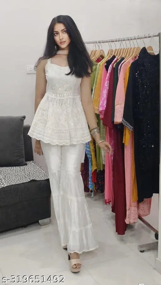 Stylish Chikankari cotton top set with sharara & dupatta in sleeveless design. Embroidered, chanderi silk bottomwear for women & girls. Perfect for parties and festivals." (124 characters)