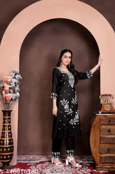 Women's viscose rayon embroidered kurta set with pants, three-quarter sleeves, single size available. Indian handcrafted traditional wear on display stand