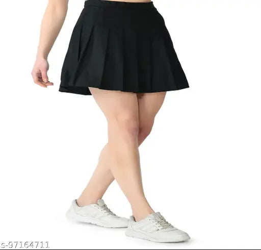 Solid polyester checked pleated mini tennis skirt with attached shorts for active women, high waist and above knee. Suitable for various sports activities or casual wear. Machine washable for easy care. Available sizes: 24/XS (Waist 24 in, Length 17 in), 26/S (Waist 26 in, Length 17 in), 28/M (Waist 28 in, Length 17 in), 30/L (Waist 30 in, Length 17 in), 32/XL (Waist 32 in, Length 17 in), 34/2XL (Waist 34 in, Length 18 in). Origin: India