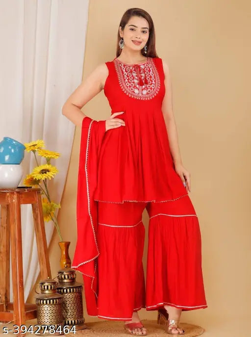 Red rayon kurta set with sharara and dupatta: Women's A-line sleveless kurti, sharara, and dupatta for festive, casual, or office wear. Lightweight, soft rayon fabric." (124 characters)