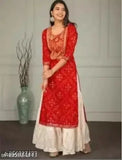 Red rayon kurti and white sharara set with three-quarter sleeves, printed net pattern, available in S, M, L, XL, XXL from Paliwal Textile India
