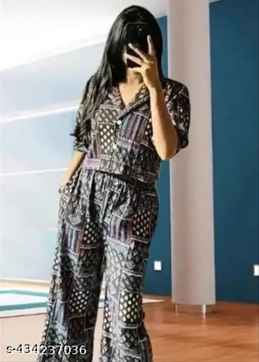 Women's rayon three-quarter sleeve jumpsuit combo in printed net pattern, showcasing various sizes on a hanger