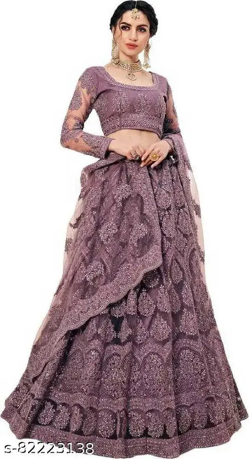 Embroidered net lehenga choli and dupatta set with heavy stonework, Indian traditional bridal outfit on display