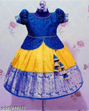 Modern trendy kids' lehenga cholis, art silk with short sleeves and printed designs. Lehenga features woven pattern while dupatta is printed. Stitched net material, available in various sizes from 12-13 years. Indian origin