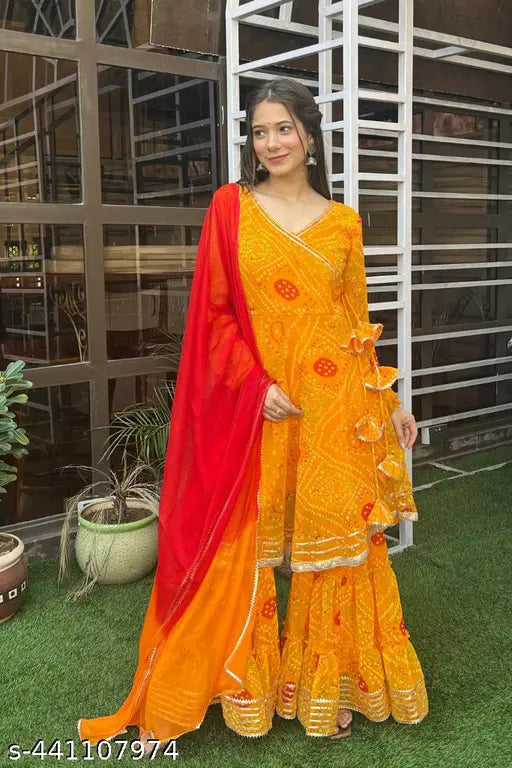 Georgette Bhandani Print Yellow Sharara Set: Indian handcrafted georgette sharara suit with long-sleeved kurta, dupatta, and bottomwear featuring Lucknowi Chikankari work. Single size available