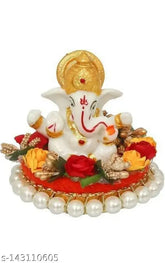 Multicolor polyresin Ganesha idol sitting on gungroo bangles, adorned by flowers. Vibrant decorative showpiece, 9 cm tall and 10 cm wide