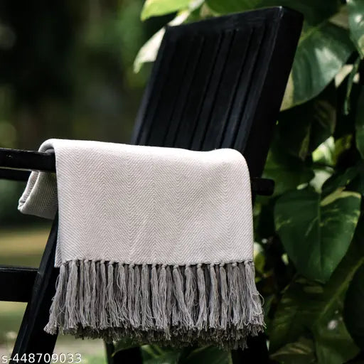 Grey herringbone cotton throw with charming flower border, elegant and versatile home decor accessory