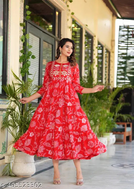 Red rayon anarkali kurta with floral print, embellished with embroidery. Floral print long dress for women, A-line shape, three-quarter sleeves, round neck. New design, under $500. Jaipuri print kurti from India