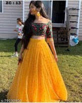 Yellow satin lehenga choli with embroidery work, free size, Indian bridal wear on mannequin