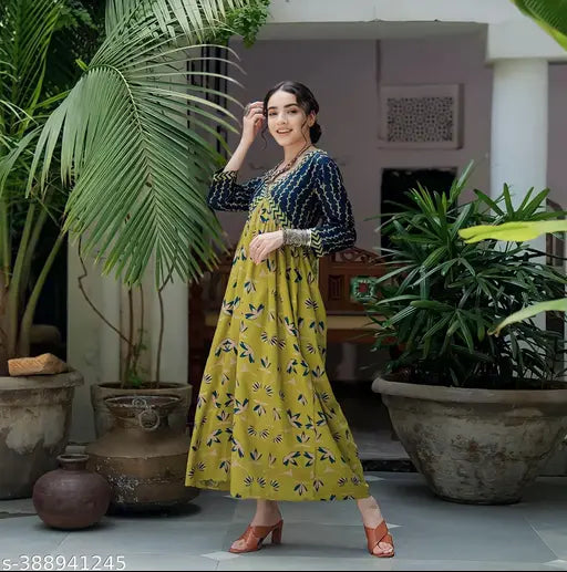 Yellow rayon botanical burst kurti gown, vibrant print and three-quarter sleeves. Perfect for parties. Made in India