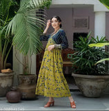 Yellow rayon botanical burst kurti gown, vibrant print and three-quarter sleeves. Perfect for parties. Made in India