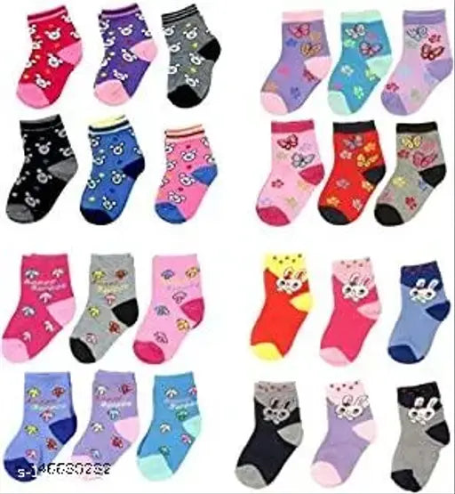 Cotton baby socks pack of 12 with adorable cartoon designs and bright colors, suitable for boys and girls from 0-21 months. Made in India (93% cotton, 5% polyester, 2% elastane)