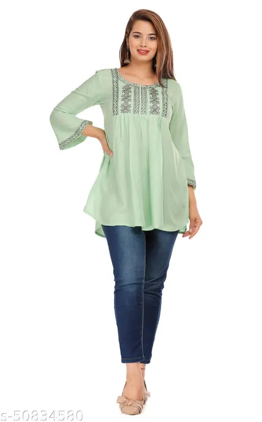Green rayon casual top with three-quarter sleeves, embroidered net pattern, perfect for women's relaxed style. Beautifully feminine and elegant, this 3/4 sleeve regular top from India