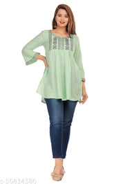 Green rayon casual top with three-quarter sleeves, embroidered net pattern, perfect for women's relaxed style. Beautifully feminine and elegant, this 3/4 sleeve regular top from India