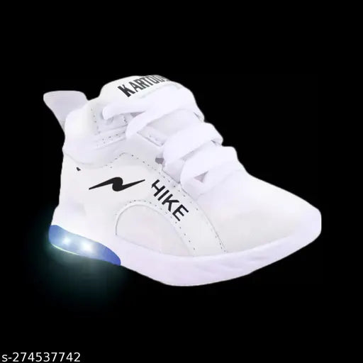 White Canvas and Rubber Light Up Kids Sneaker by Rockstar, ideal for boys aged 12 months to 6 years, features memory foam insole and velcro fastening, with an embellished net pattern and color-changing lighting effect. Made in India