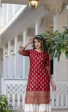 Red and white rayon kurti set with printed design, 3/4th sleeves, round neck, and palazzo bottoms. Latest trend fashion wear for women, made in India