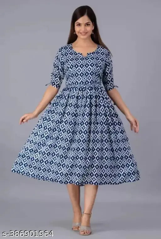 Geometric one-piece cotton dress, printed with geometric pattern. Three-quarter sleeve length. Available in sizes M, L, XL, XXL. Made in India