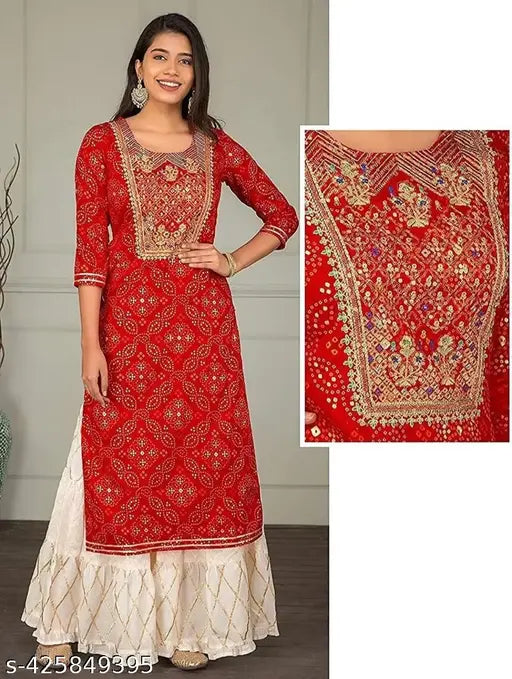 Red embroidered Rayon kurta with Sharara bottom, three-quarter sleeves, round neck. Indian printed net design