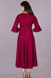 Maroon rayon solid flared kurti with three-quarter sleeves, suitable for casual and formal occasions. Hand wash or machine wash care. One readymade kurti per packet. Size based on two inches more than body measurement. Color may slightly vary due to lighting sources