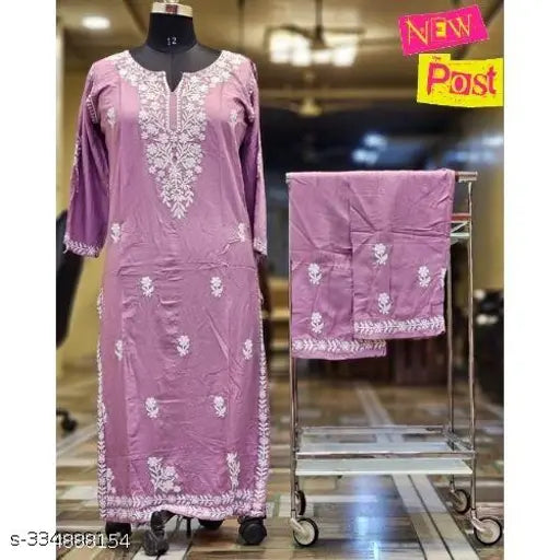Rayon Chikankari embroidered kurta with plazzo, three-quarter sleeves, round neck, and straight knee length. Embroidered net Indian fashion wear on display stand
