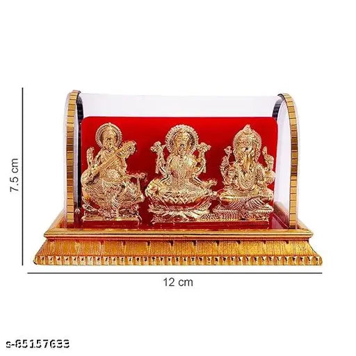 Golden plastic Lord Ganesh, Lakshmi, Saraswati idols set from India on display