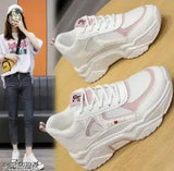 Pink synthetic shoes with a heart design, featuring rubber soles and lace-up net detail. Available in sizes 3 to 8 (5in - 7.5in). Made in India