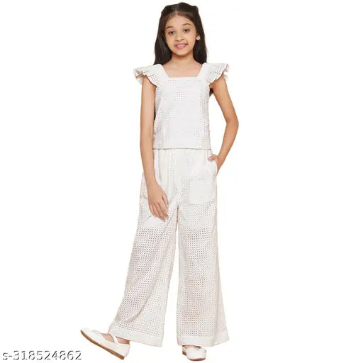 White cotton schiffli embroidered cuff sleeve top and elasticated pant girls set, self-design Indian kurta with bottomwear on model