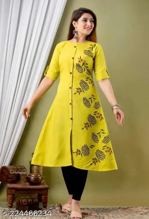 Green printed quirky round cotton kurti with short sleeves, featuring delicate lace detailing and a V-neck. Made in India