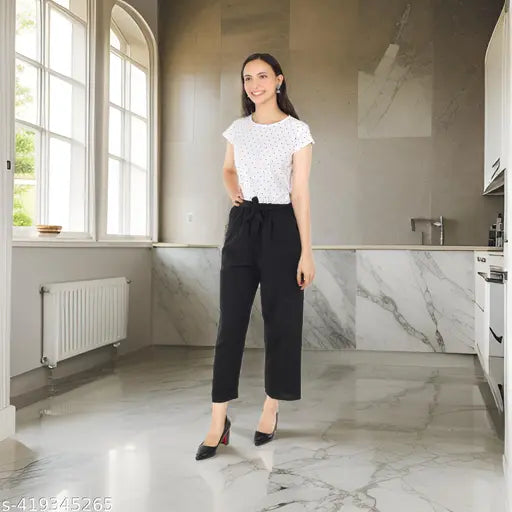 White crepe jumpsuit with black dot print by Pearl N Vera, suitable for casual or semi-formal events. High-quality crepe fabric offers comfort and durability. Sizes: S (Bust 32", Length 52", Waist 28"), M (Bust 34", Length 53", Waist 30"), L (Bust 36", Length 54", Waist 32"), XL (Bust 38", Length 55", Waist 34"), Free Size (Bust 37", Length 55", Waist 34"). Machine wash gentle or hand wash, do not bleach. Country of Origin: India