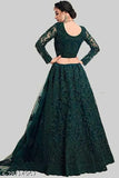 Green net lehenga choli and dupatta set, embroidered with semi-stitching, Patlani chain, and stonework. Indian traditional outfit on mannequin