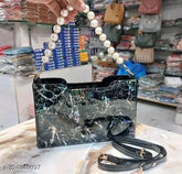 Marble design PU handheld and sling bag with pearl handle. Pearl-toned printed net carryall accessory from India