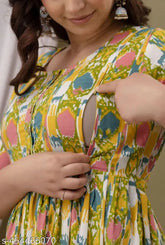Yellow cotton maternity kurti/gown with ikat print and three-quarter sleeves. Adjustable back robe, discreet feeding access, and inner covers to prevent rashes. Made in India, available in various sizes from S to XXXL
