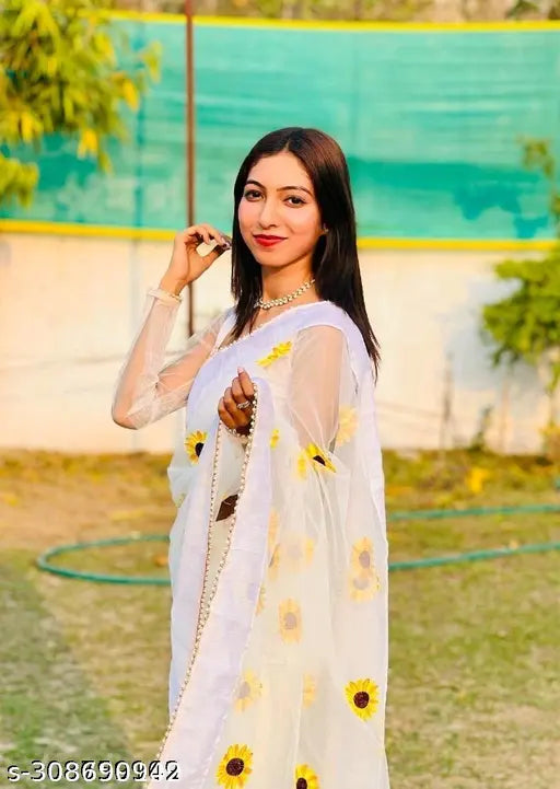 White net Bollywood-style saree with embroidered motif and unstitched blouse, perfect for parties and festivals. Indian handcrafted fashion accessory