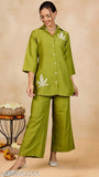 WineRed woman solid green leaf embroidery co-ord set with short sleeves, polyester fabric, 3/4th sleeve with placement embroidery, self tie-up, pant with one pocket, elasticated waistband, slip on closure. Made in India