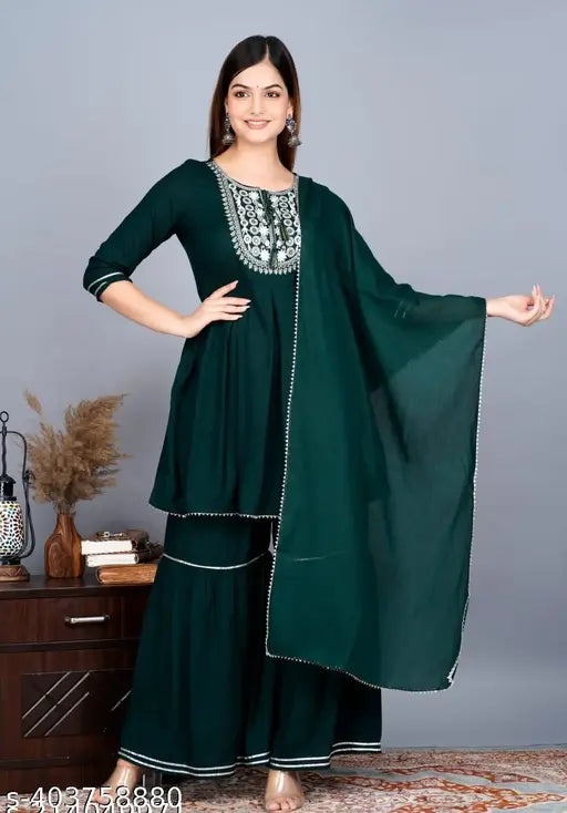 Green rayon embroidered short designer kurti-sharara set with dupatta. Solid green sharara dress for women on display." (104 characters)